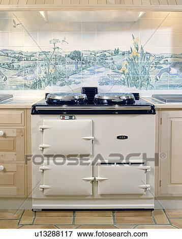 Cream Aga oven and pictorial tiled wall View Large Photo Image Stock Photo - Cream Aga oven and pictorial tiled wall. Fotosearch