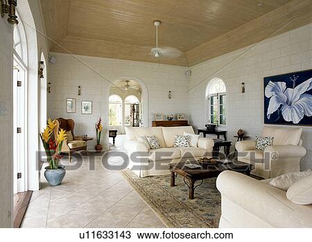 Cream sofas and wooden ceiling in large Caribbean living room View Large Photo Image Stock Image - Cream sofas and wooden ceiling in large Caribbean living room. Fotosearch