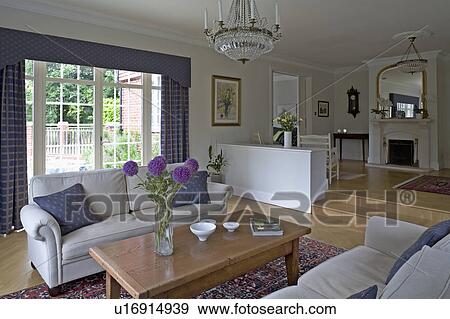 Stock Photograph Of Cream Sofas And Wooden Table In Airy Country Cream Sofas And Wooden Table In Airy Country Living Room