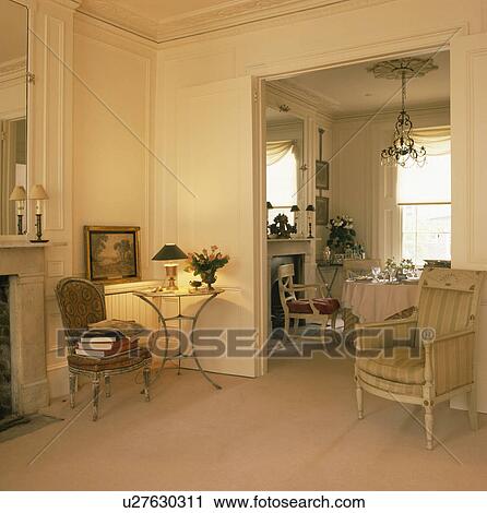 Cream townhouse living room with double doorway to dining room View Large Photo Image Stock Image - Cream townhouse living room with double doorway to dining room. Fotosearch