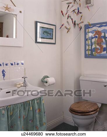 Curtained storage below white basin in small white family bathroom View Large Photo Image Stock Image - Curtained storage below white basin in small white family bathroom. Fotosearch