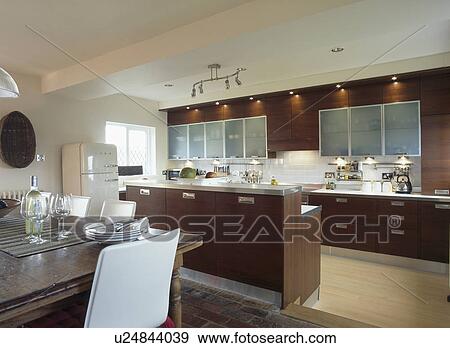Dark brown fitted units in modern kitchen dining room View Large Photo Image Stock Photo - Dark brown fitted units in modern kitchen dining room. Fotosearch