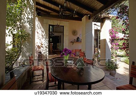 Dining table and chairs on veranda of house in Mallorca View Large Photo Image Stock Image - Dining table and chairs on veranda of house in Mallorca. Fotosearch