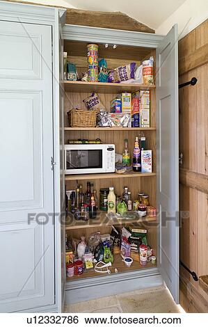 Door open to fitted larder storage cupboard with microwave View Large Photo Image Stock Photograph - Door open to fitted larder storage cupboard with microwave. Fotosearch