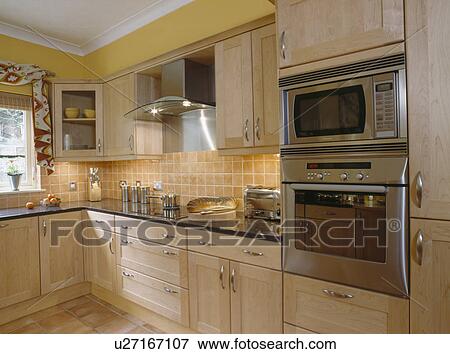 Double oven in modern yellow kitchen View Large Photo Image Stock Photo - Double oven in modern yellow kitchen. Fotosearch