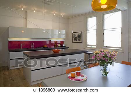 Downlighting in modern kitchen with island unit with white gloss lacquer units View Large Photo Image Stock Image - Downlighting in modern kitchen with island unit with white gloss lacquer units. Fotosearch