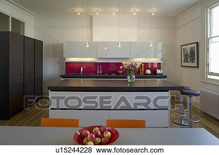 Downlighting in modern kitchen with island unit with cast concrete resin worktop View Large Photo Image Stock Photo - Downlighting in modern kitchen with island unit with cast concrete resin worktop. Fotosearch