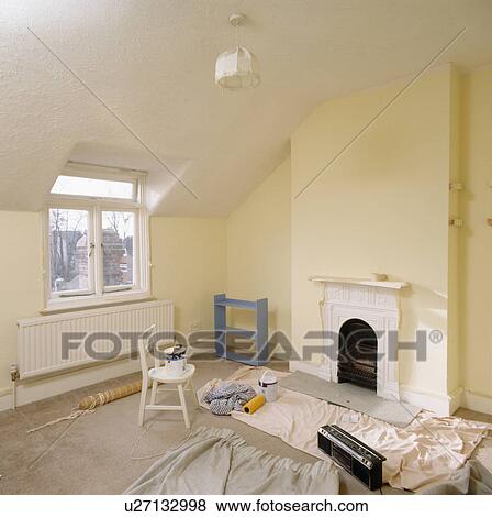 Dustsheets and decorating materials on floor on attic room with small white fireplace View Large Photo Image Stock Photo - Dustsheets and decorating materials on floor on attic room with small white fireplace. Fotosearch