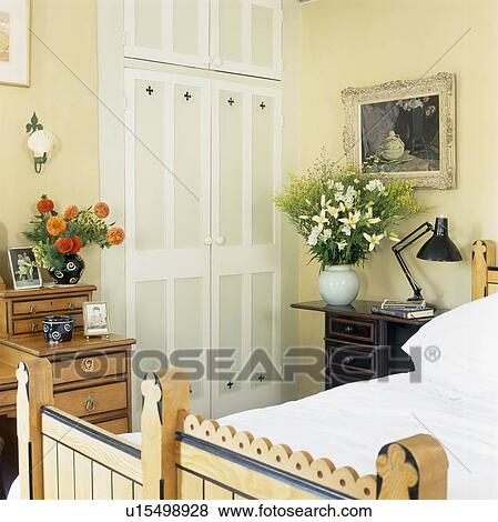Fitted wardrobe with painted doors in cream bedroom View Large Photo Image Stock Photo - Fitted wardrobe with painted doors in cream bedroom. Fotosearch