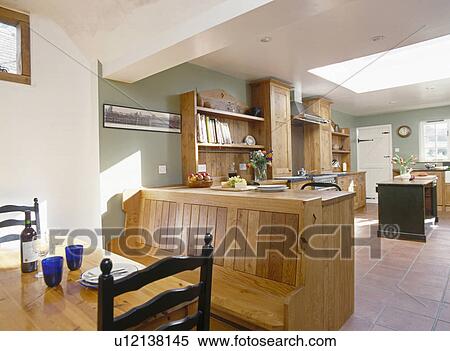 Fitted wooden bench seating at table in large kitchen extension View Large Photo Image Stock Photography - Fitted wooden bench seating at table in large kitchen extension. Fotosearch