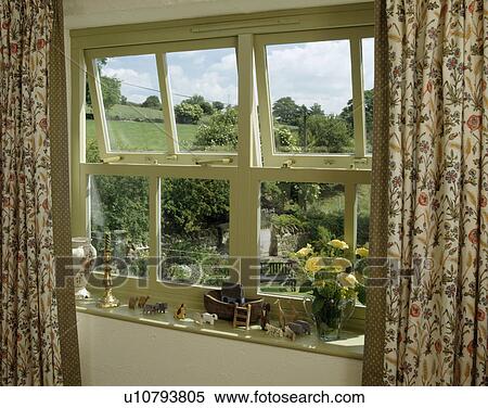 Floral curtains at window with view of the countryside View Large Photo Image Stock Photography - Floral curtains at window with view of the countryside. Fotosearch