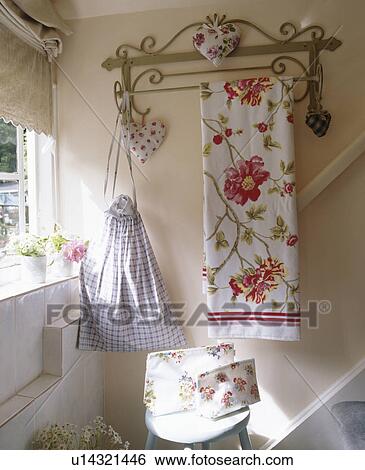 Floral towel on rack above cottage stairs View Large Photo Image Stock Photograph - Floral towel on rack above cottage stairs. Fotosearch