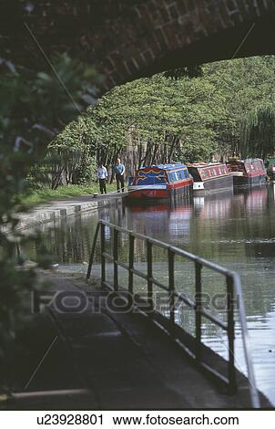 Footpath below bridge over the Regent Canal in London with narrow boats moored on the bank View Large Photo Image Stock Image - Footpath below bridge over the Regent Canal in London with narrow boats moored on the bank. Fotosearch