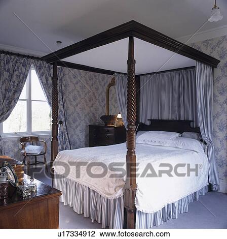 Four Poster Bed With Pastel Blue Drapes In Bedroom With Pastel