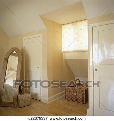 Stock Photo - Freestanding mirror in attic bedroom. Fotosearch