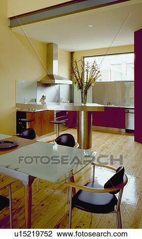 Glass dining table in modern open-plan kitchen dining room with pale wooden flooring View Large Photo Image Stock Image - Glass dining table in modern open-plan kitchen dining room with pale wooden flooring. Fotosearch