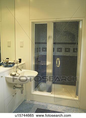 Glass Doors On Shower Cabinet In Modern White Bathroom Stock
