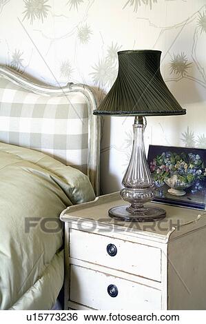Glass lamp with black shade on small cream bedside cabinet View Large Photo Image Stock Photograph - Glass lamp with black shade on small cream bedside cabinet. Fotosearch