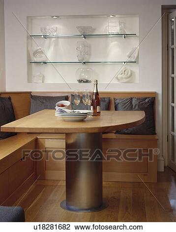 Glass shelves in alcove above fitted wooden seating in modern dining room View Large Photo Image Stock Image - Glass shelves in alcove above fitted wooden seating in modern dining room. Fotosearch