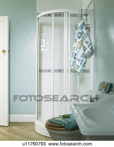 Glass shower cabinet in corner of pastel blue bagthroom View Large Photo Image Stock Image - Glass shower cabinet in corner of pastel blue bagthroom. Fotosearch