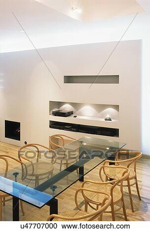 Glass table and plywood and cane chairs in modern dining room View Large Photo Image Stock Image - Glass table and plywood and cane chairs in modern dining room. Fotosearch