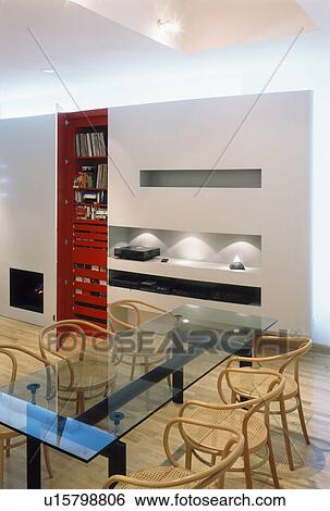 Glass table and plywood and cane chairs in modern dining room View Large Photo Image Stock Photograph - Glass table and plywood and cane chairs in modern dining room. Fotosearch