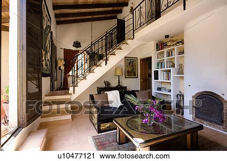 Glass-topped coffee table in open-plan Mediterranean hall living room View Large Photo Image Stock Image - Glass-topped coffee table in open-plan Mediterranean hall living room. Fotosearch