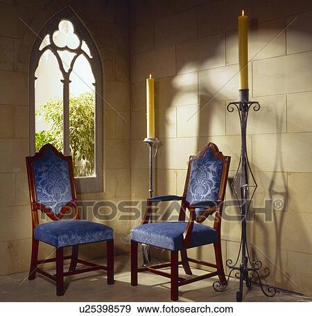 Gothic-style chairs with blue upholstery in country hall with stone walls and Gothic window View Large Photo Image Stock Photo - Gothic-style chairs with blue upholstery in country hall with stone walls and Gothic window. Fotosearch