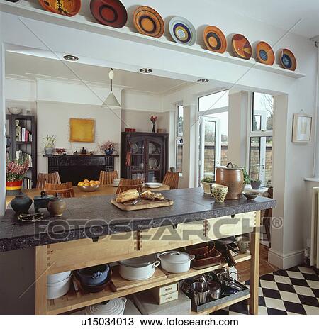 Granite topped freestanding shelf unit dividing modern kitchen and dining room View Large Photo Image Stock Image - Granite topped freestanding shelf unit dividing modern kitchen and dining room. Fotosearch