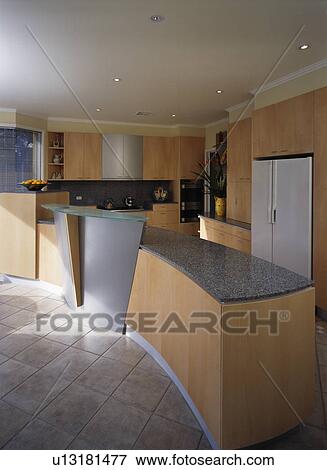 Granite worktop on peninsular unit in modern kitchen with ceramic flooring View Large Photo Image Stock Photo - Granite worktop on peninsular unit in modern kitchen with ceramic flooring. Fotosearch