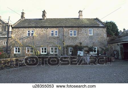 Gravel drive and low wall in front of stone country cottage View Large Photo Image Stock Image - Gravel drive and low wall in front of stone country cottage. Fotosearch