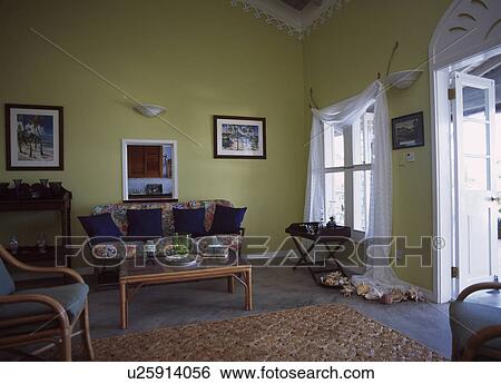 Stock Photograph - Green living room with white curtains in house in the West Indians. Fotosearch