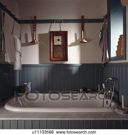 Green panelling above white bath in Shaker-style bathroom View Large Photo Image Stock Photo - Green panelling above white bath in Shaker-style bathroom. Fotosearch