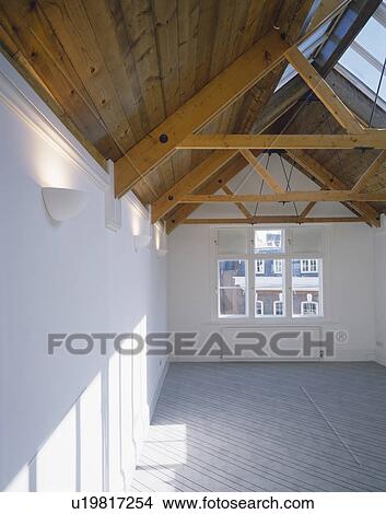 Grey carpet and apex ceiling in empty attic room View Large Photo Image Picture - Grey carpet and apex ceiling in empty attic room. Fotosearch