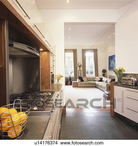 Grey flooring in kitchen leading into townhouse living room with white carpet View Large Photo Image Picture - Grey flooring in kitchen leading into townhouse living room with white carpet. Fotosearch