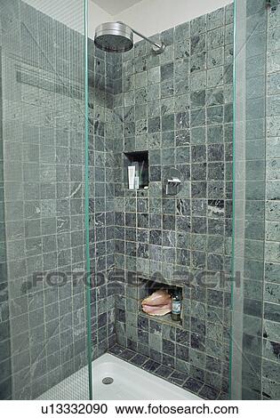 Stock Image - Grey limestone tiles in modern shower room. Fotosearch