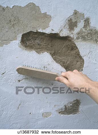 Hand using brush on damaged plaster wall View Large Photo Image Stock Image - Hand using brush on damaged plaster wall. Fotosearch