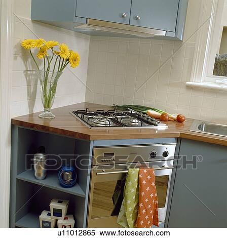 Stock Photography - Hob and oven in fitted corner unit in modern kitchen. Fotosearch