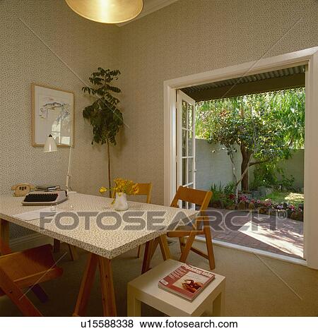 Home office with open French windows to small garden View Large Photo Image Stock Photo - Home office with open French windows to small garden. Fotosearch