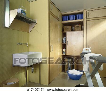 Picture - Ironing board in modern utility room. Fotosearch