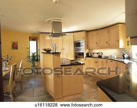 Island unit in fitted kitchen with black granite worktops View Large Photo Image Stock Photo - Island unit in fitted kitchen with black granite worktops. Fotosearch
