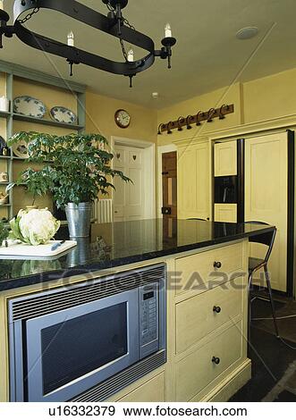 Stock Photograph Of Island Unit With Ed Microwave Oven In Modern Island Unit With Ed Microwave Oven In Modern Country Kitchen