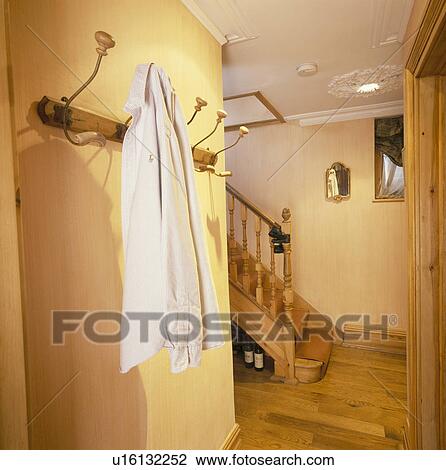 Jacket on wall-hooks in traditional yellow hall with wooden flooring View Large Photo Image Stock Image - Jacket on wall-hooks in traditional yellow hall with wooden flooring. Fotosearch