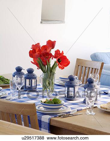 Lanterns and vase of red tulips on table set for lucnh with blue checked cloth and striped plates View Large Photo Image Stock Photo - Lanterns and vase of red tulips on table set for lucnh with blue checked cloth and striped plates. Fotosearch