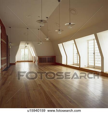 Large empty office space with wooden flooring View Large Photo Image Stock Photo - Large empty office space with wooden flooring. Fotosearch