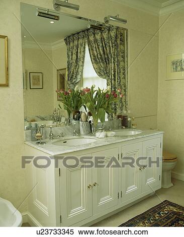 Large fitted mirror above underset basins in vanity unit in modern bathroom View Large Photo Image Stock Photography - Large fitted mirror above underset basins in vanity unit in modern bathroom. Fotosearch