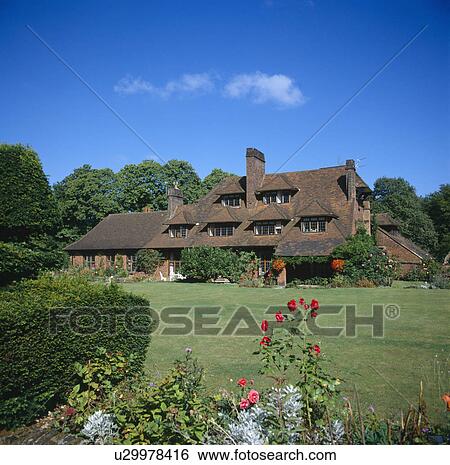 Large Lutyens-style country house set in lawns with summer flowering borders View Large Photo Image Stock Photograph - Large Lutyens-style country house set in lawns with summer flowering borders. Fotosearch