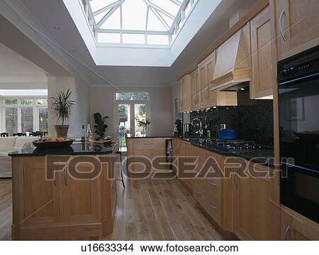 Large modern kitchen with skylight and woodern flooring View Large Photo Image Picture - Large modern kitchen with skylight and woodern flooring. Fotosearch