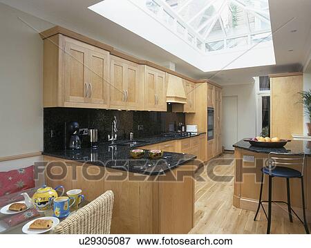 Large modern kitchen with skylight and woodern flooring View Large Photo Image Stock Photo - Large modern kitchen with skylight and woodern flooring. Fotosearch