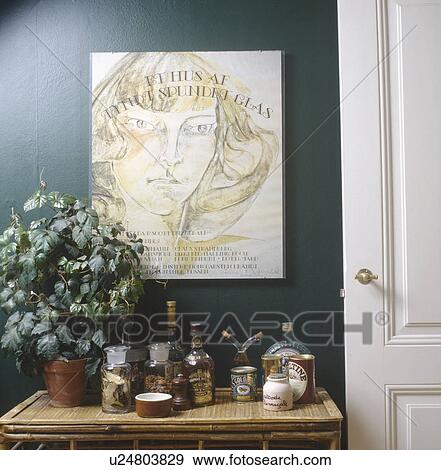 Stock Photo - Large poster above table with houseplant and jars of herbs and spices. Fotosearch
